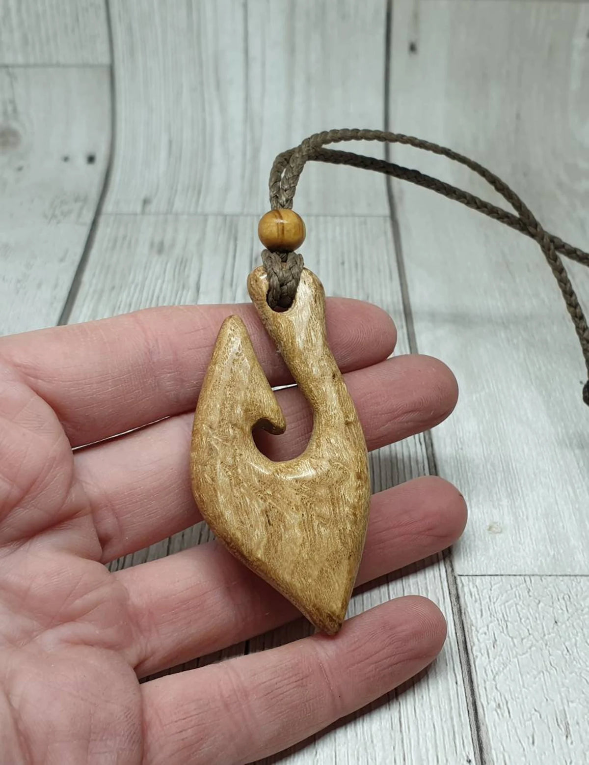 Ash wood hei matau fish hook pendant.