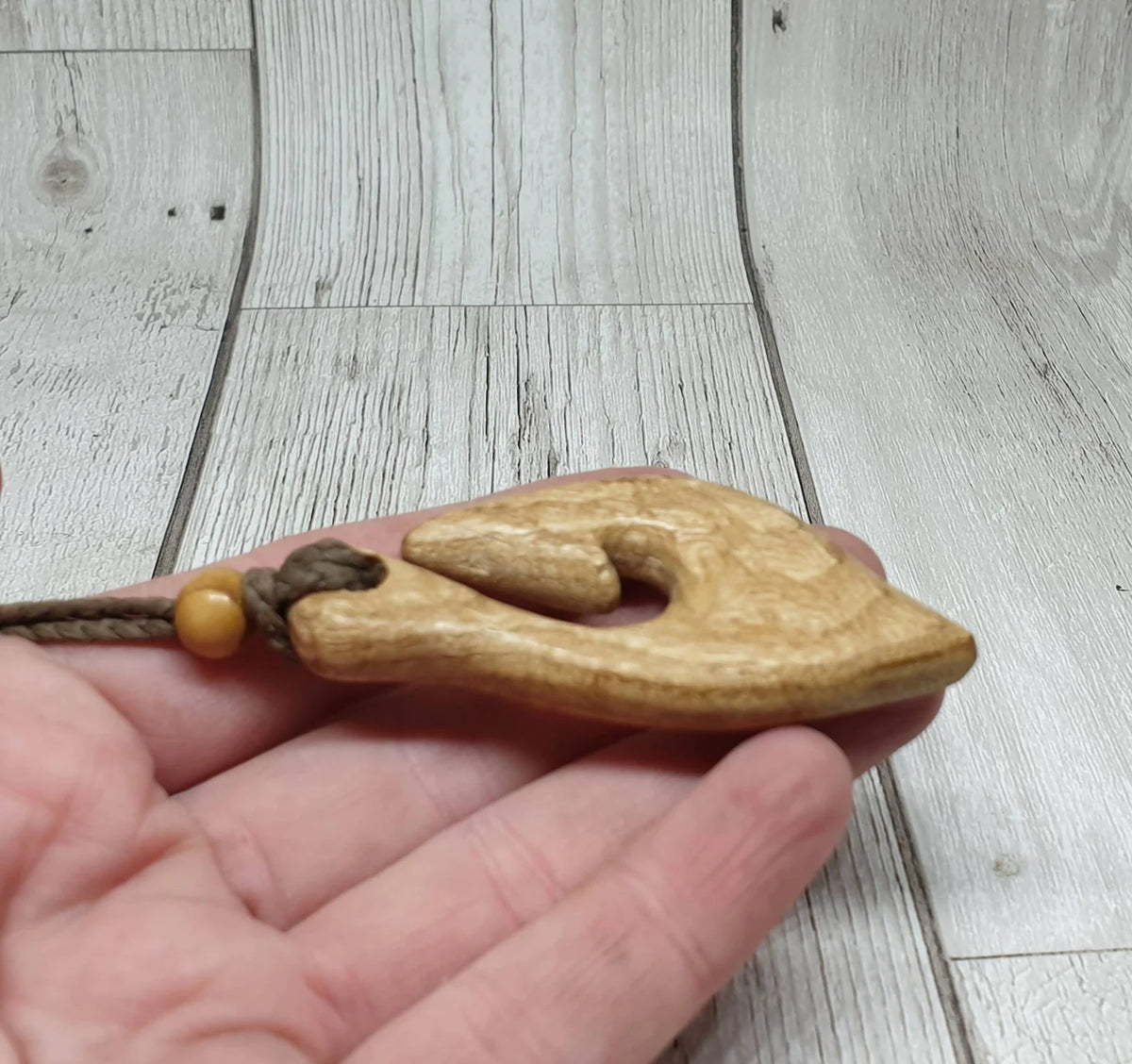 Ash wood hei matau fish hook pendant.