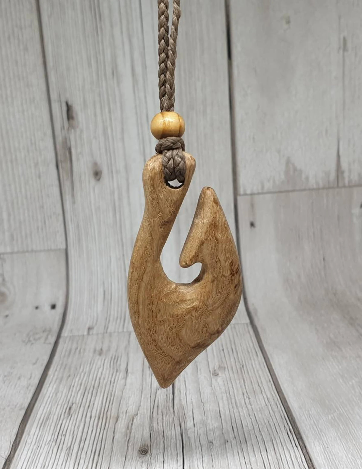 Ash wood hei matau fish hook pendant.