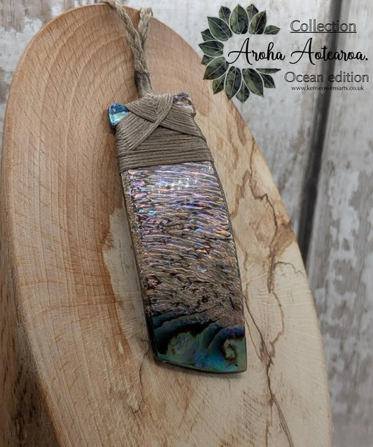 Wild New Zealand rainbow Pāua Hei toki adze pendant.