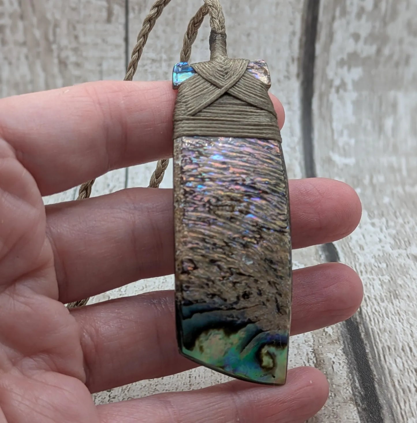 Wild New Zealand rainbow Pāua Hei toki adze pendant.