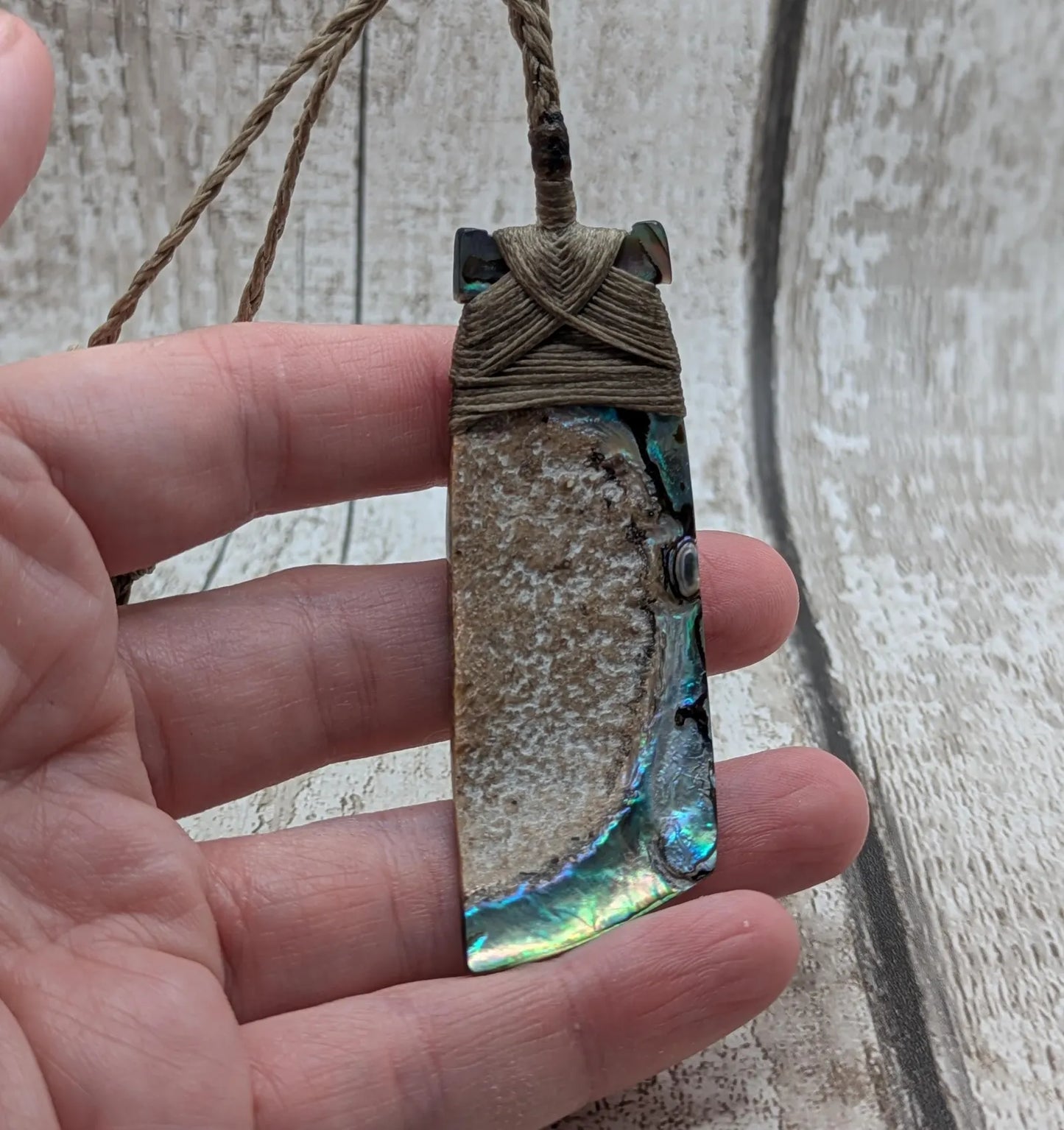 Wild New Zealand rainbow Pāua Hei toki adze pendant.