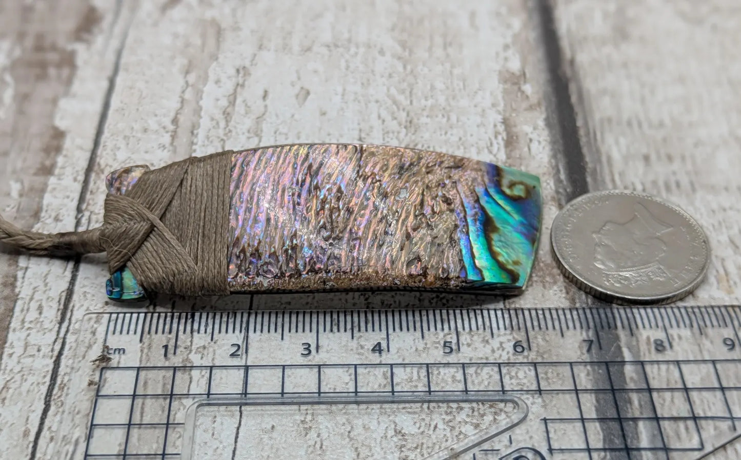 Wild New Zealand rainbow Pāua Hei toki adze pendant.