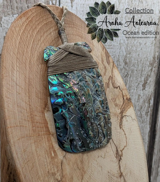 Wild New Zealand rainbow Pāua Hei Toki adze pendant.