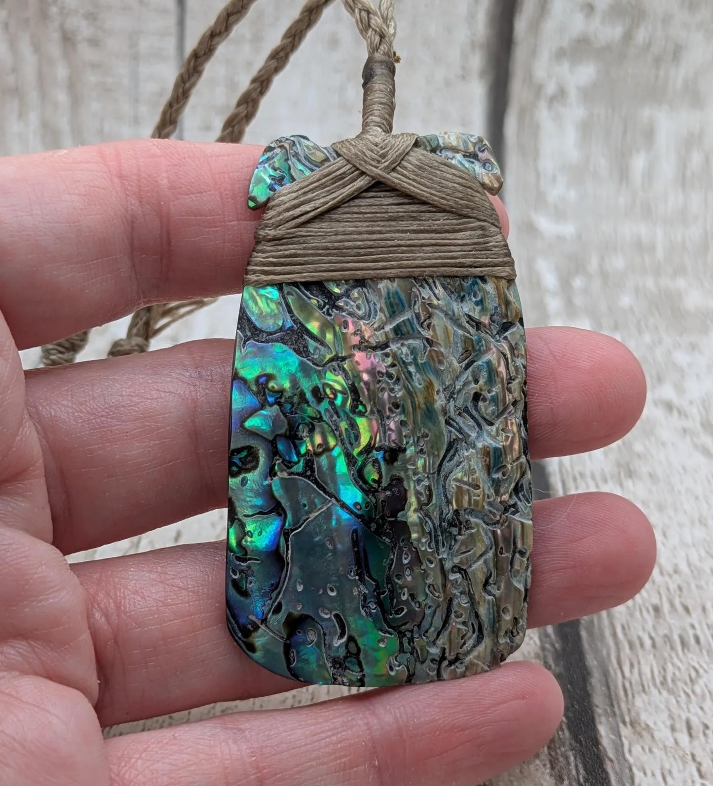 Wild New Zealand rainbow Pāua Hei Toki adze pendant.