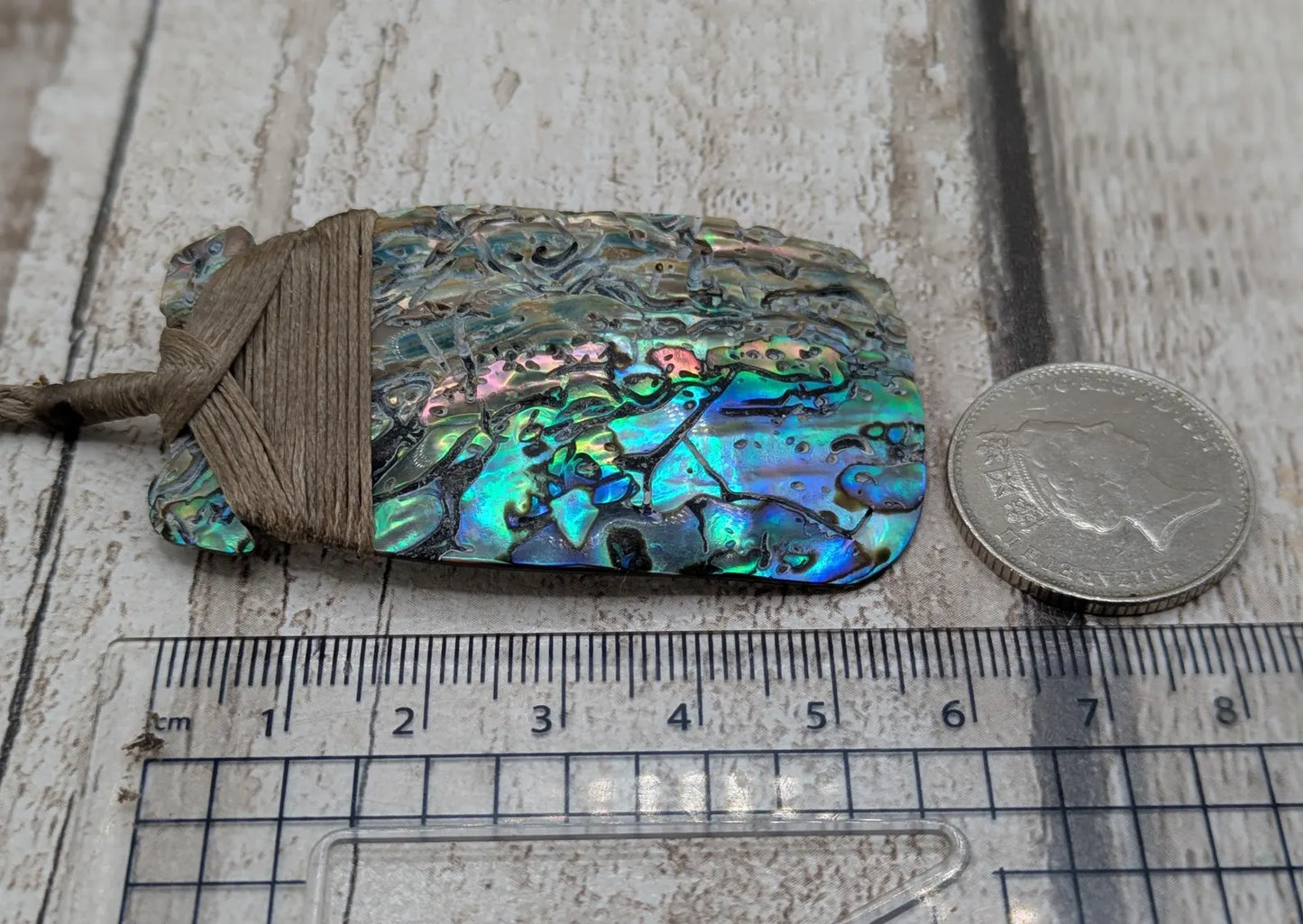 Wild New Zealand rainbow Pāua Hei Toki adze pendant.