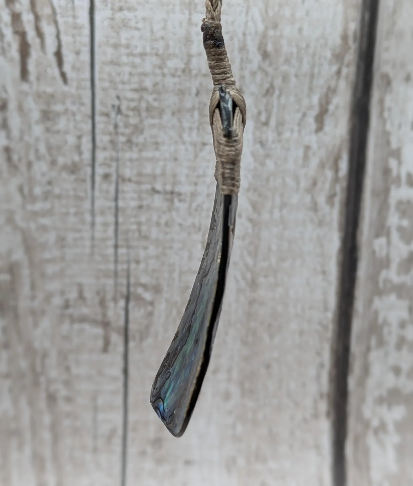 Wild New Zealand rainbow Pāua Hei Toki adze pendant.