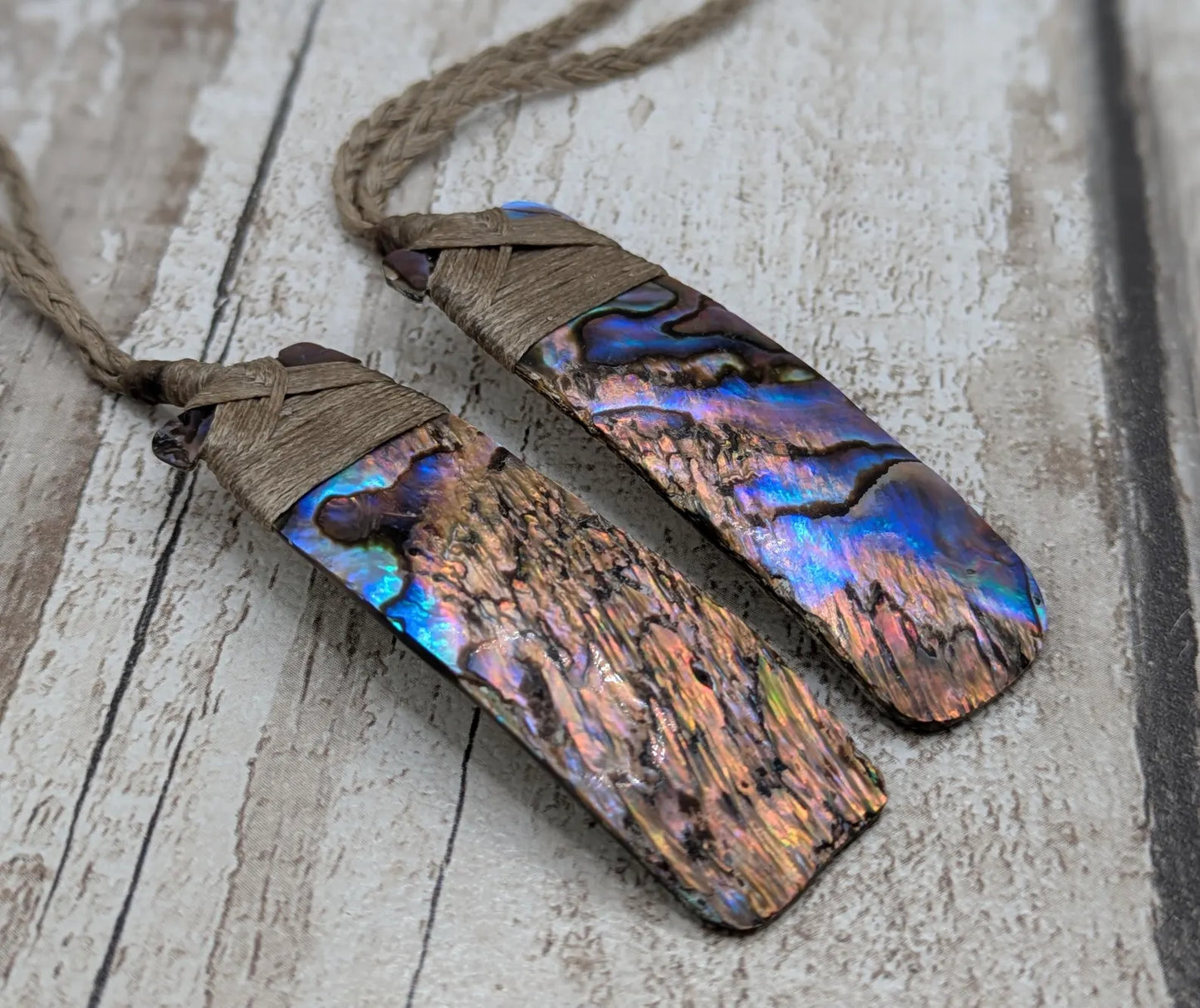 One New Zealand wild rainbow Pāua Hei Toki adze pendant.