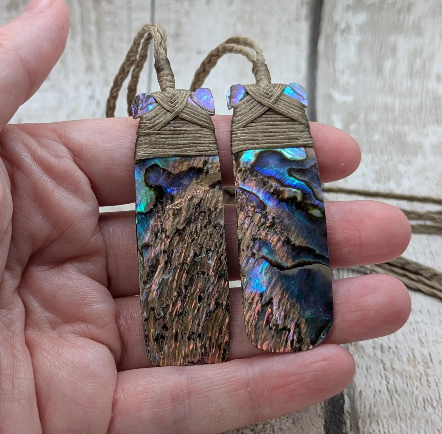 One New Zealand wild rainbow Pāua Hei Toki adze pendant.