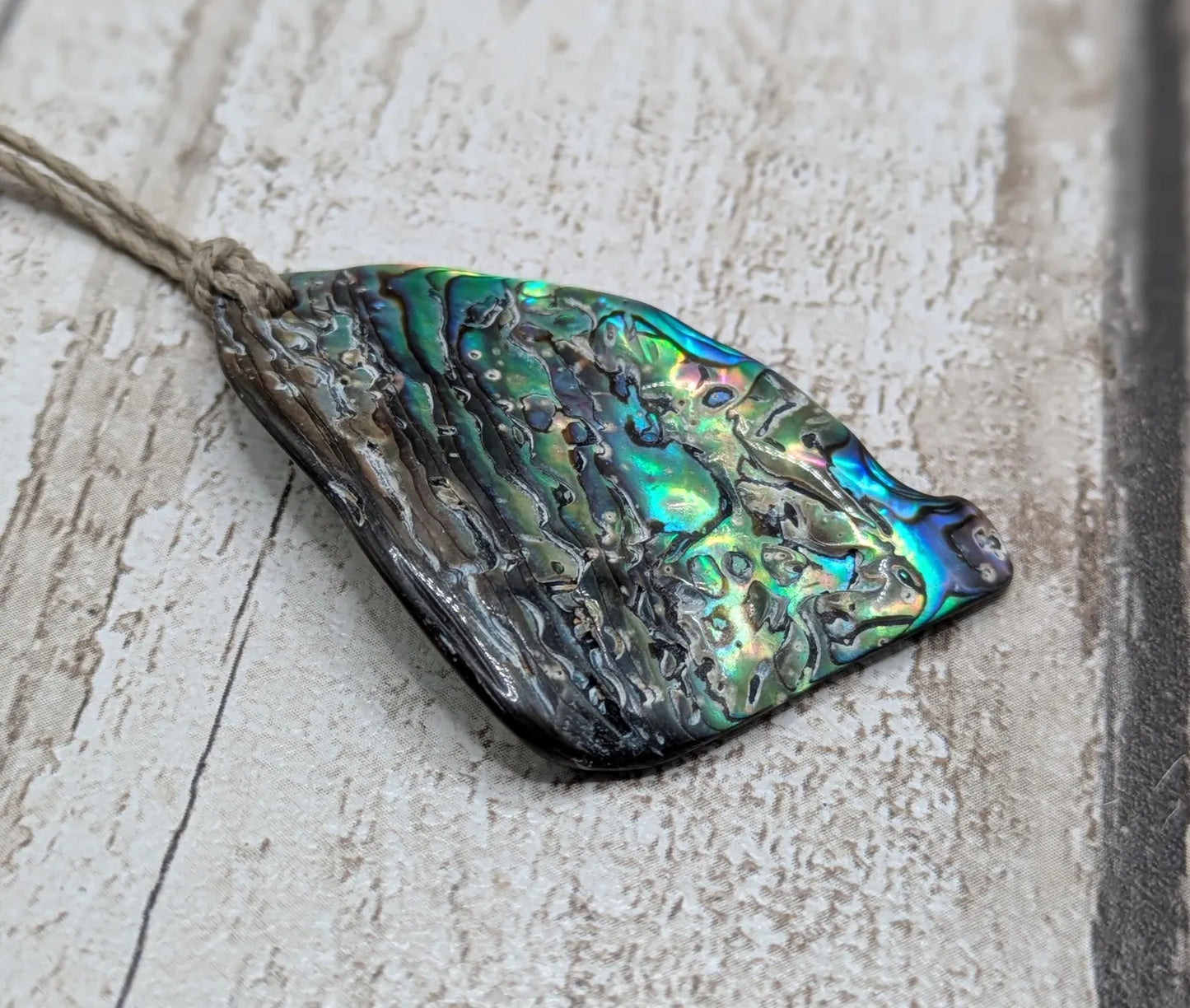 Wild natural tumbled New Zealand Pāua free form pendant.