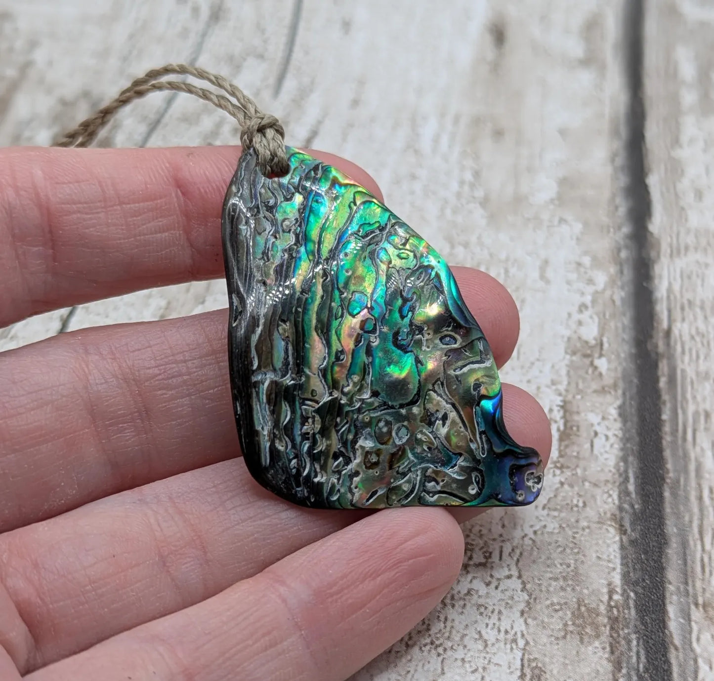 Wild natural tumbled New Zealand Pāua free form pendant.