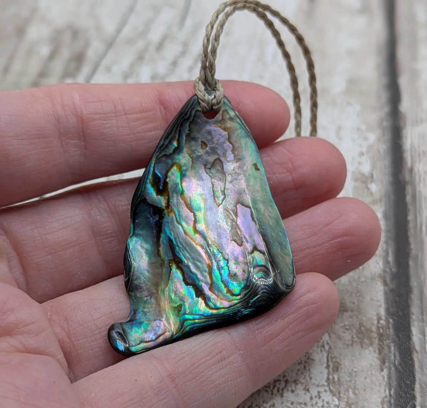 Wild natural tumbled New Zealand Pāua free form pendant.
