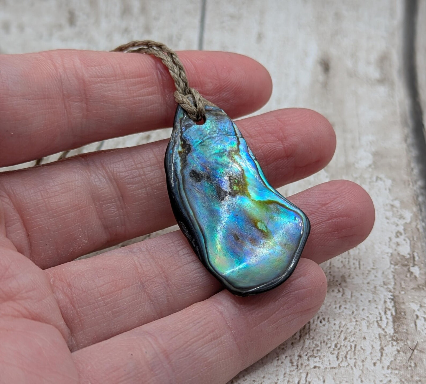 New Zealand free form wild tumbled rainbow Pāua pendant.