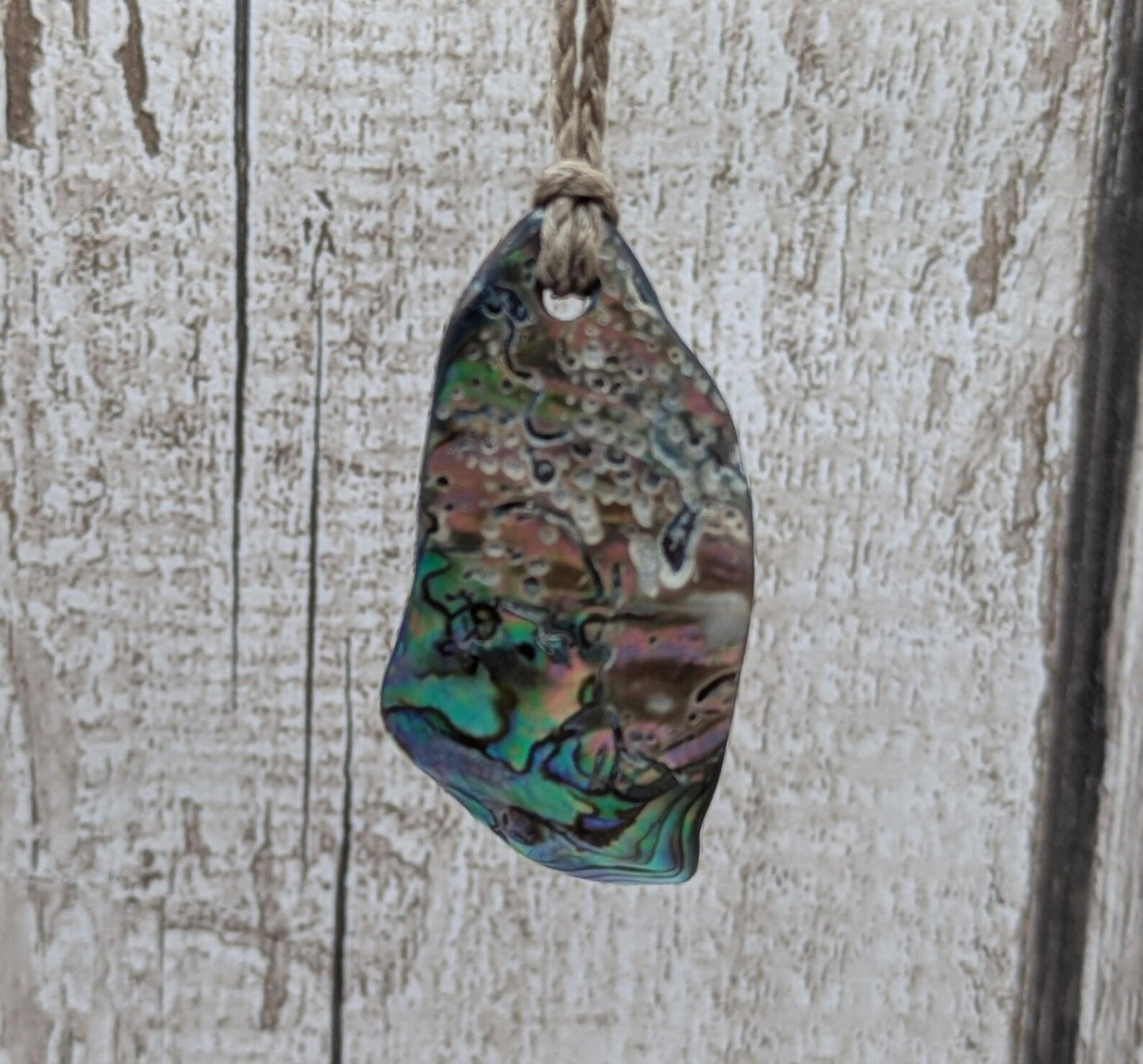 New Zealand free form wild tumbled rainbow Pāua pendant.