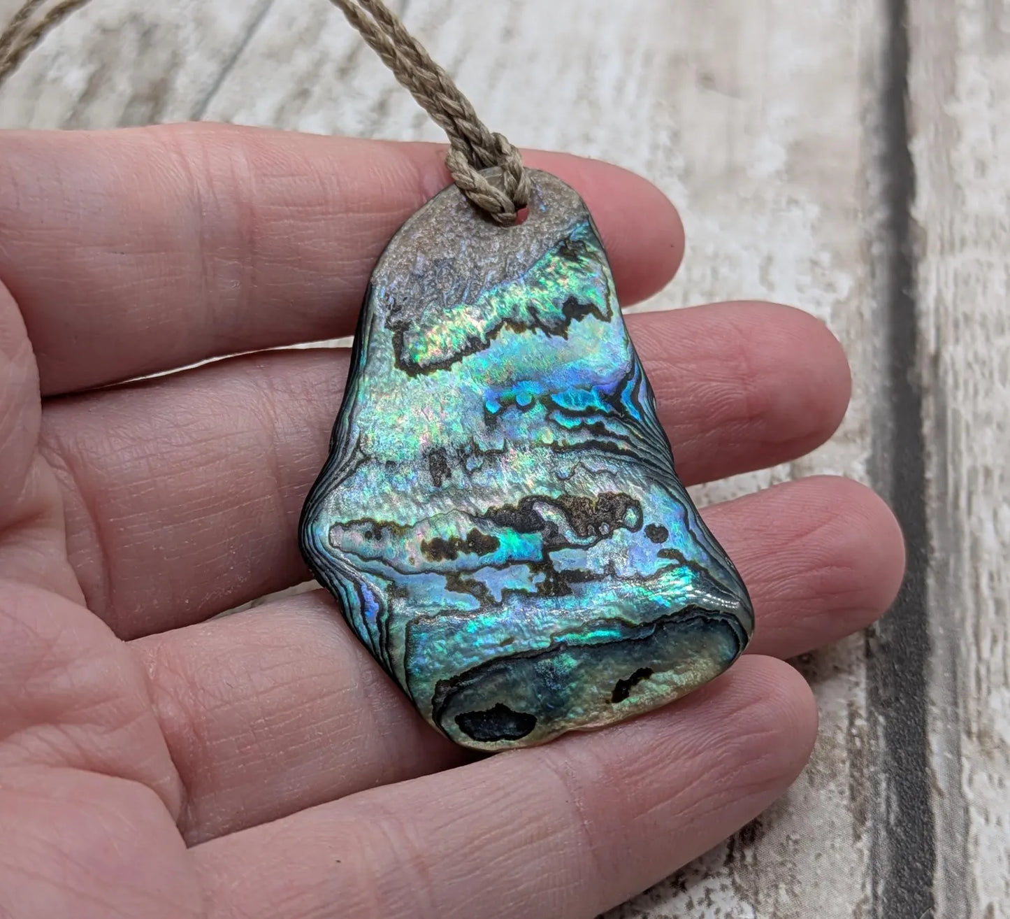 New Zealand free form naturally tumbled Pāua shell pendant.