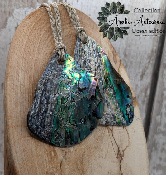 Free form naturally tumbled New Zealand rainbow Pāua pendant.