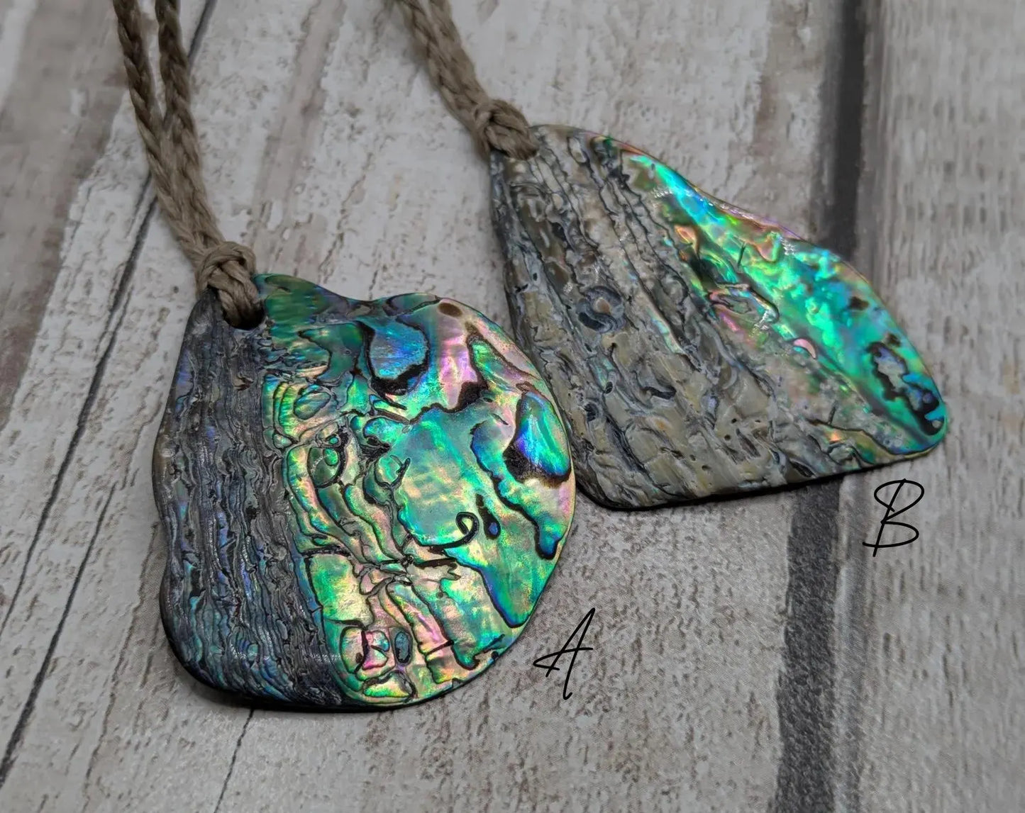 Free form naturally tumbled New Zealand rainbow Pāua pendant.