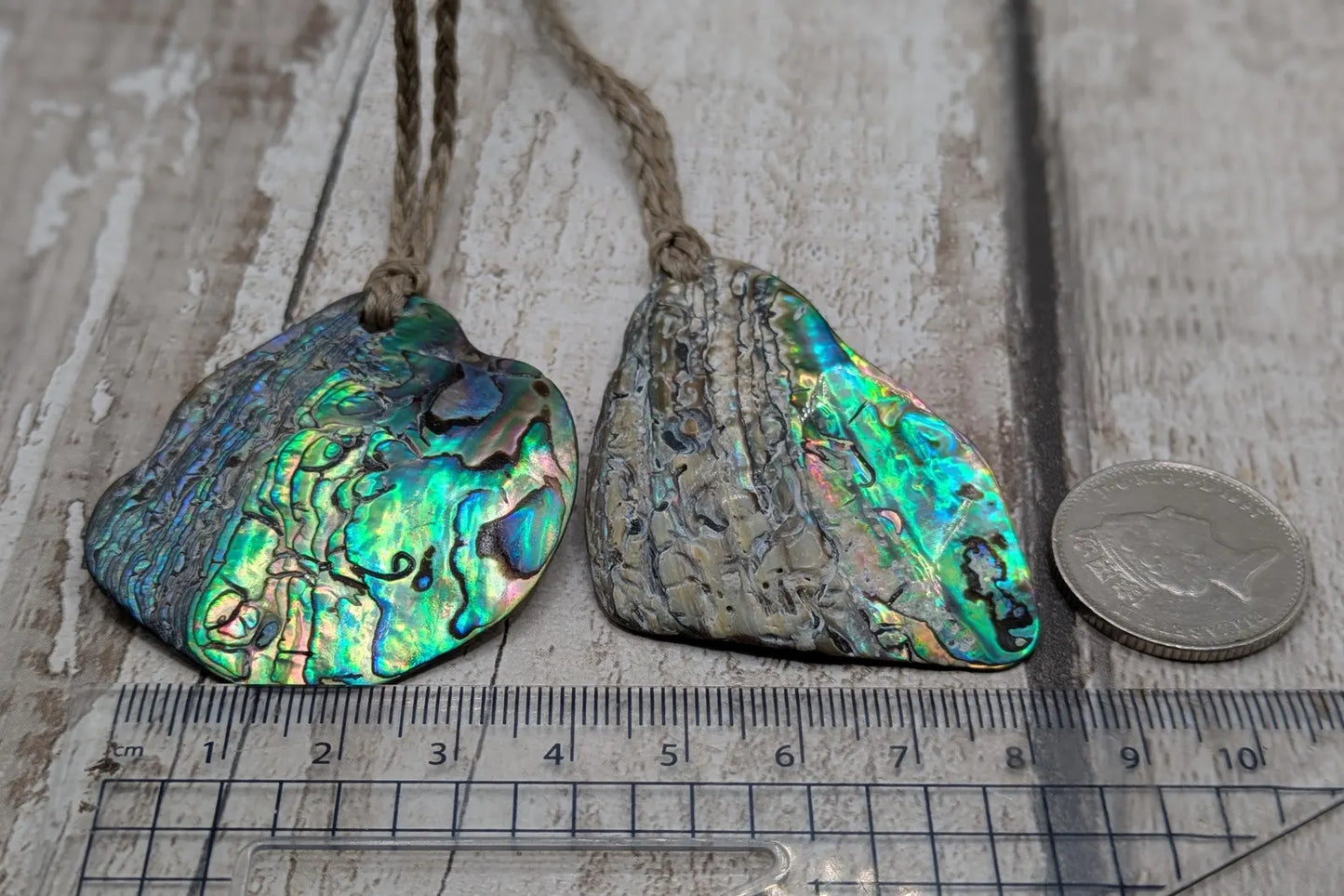 Free form naturally tumbled New Zealand rainbow Pāua pendant.