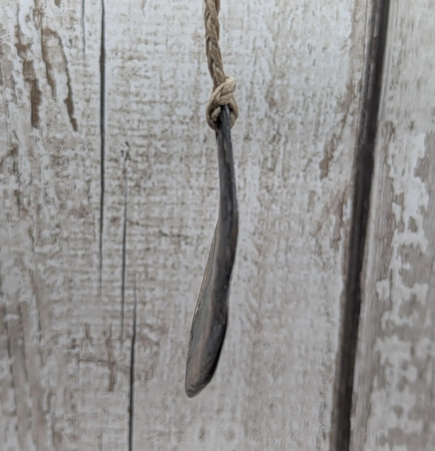 Free form naturally tumbled New Zealand rainbow Pāua pendant.