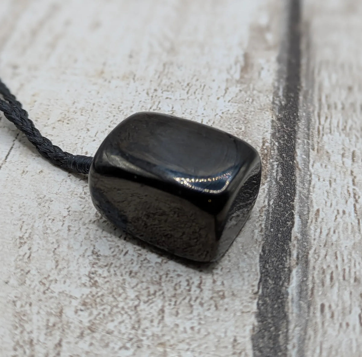 Tumble polished Whitby jet.
