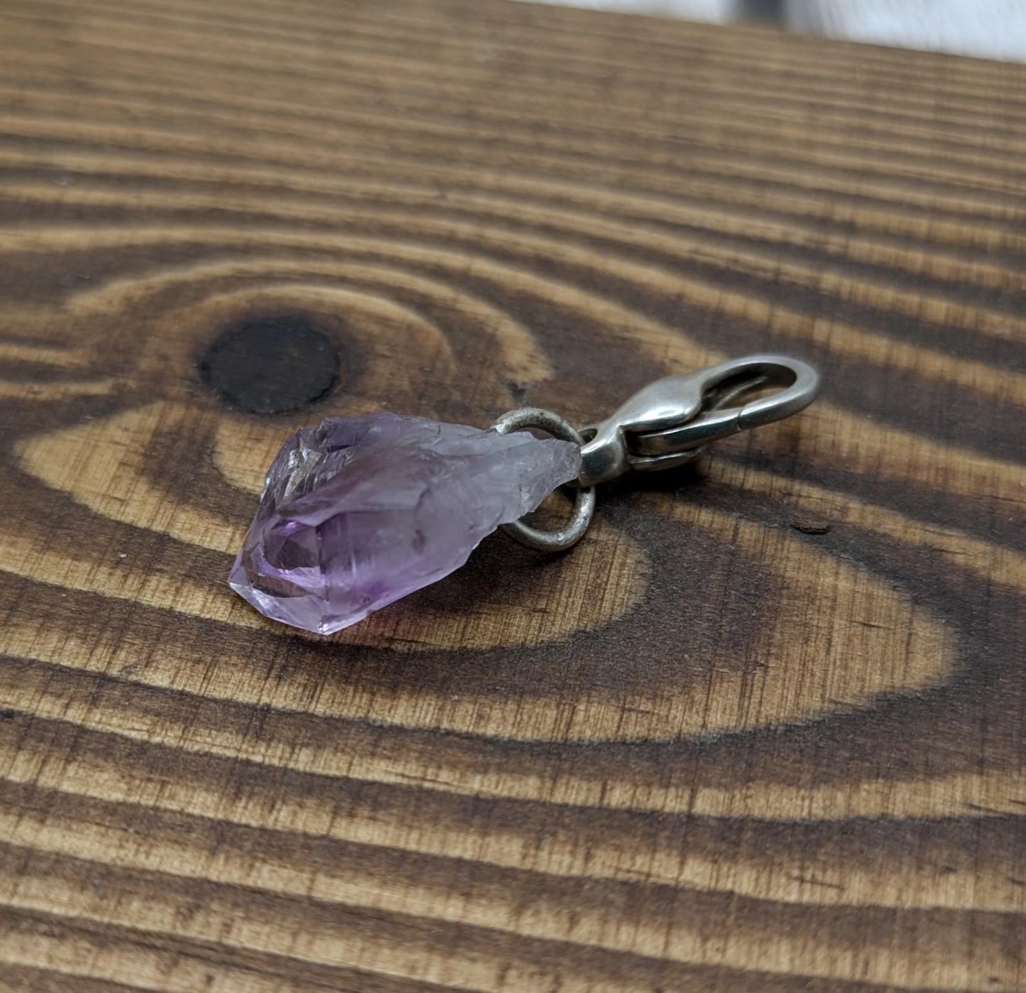 Raw amethyst point clip on charm.