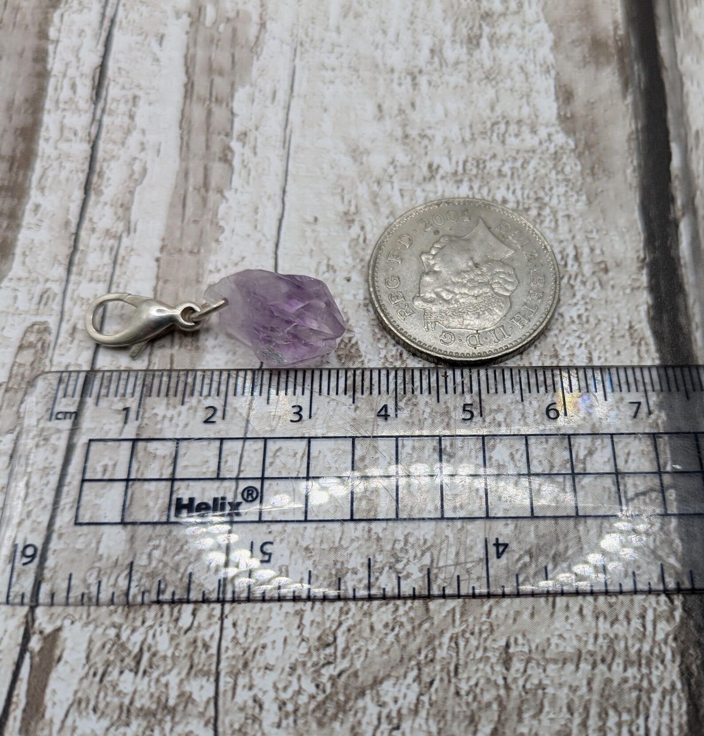 Raw amethyst point clip on charm.