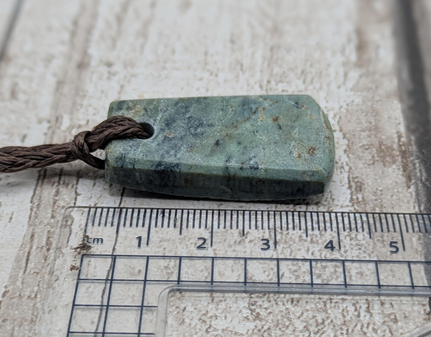 new Zealand pounamu greenstone jade pendant Off cut slice, raw weathered back, cultural and spiritual amulet.
