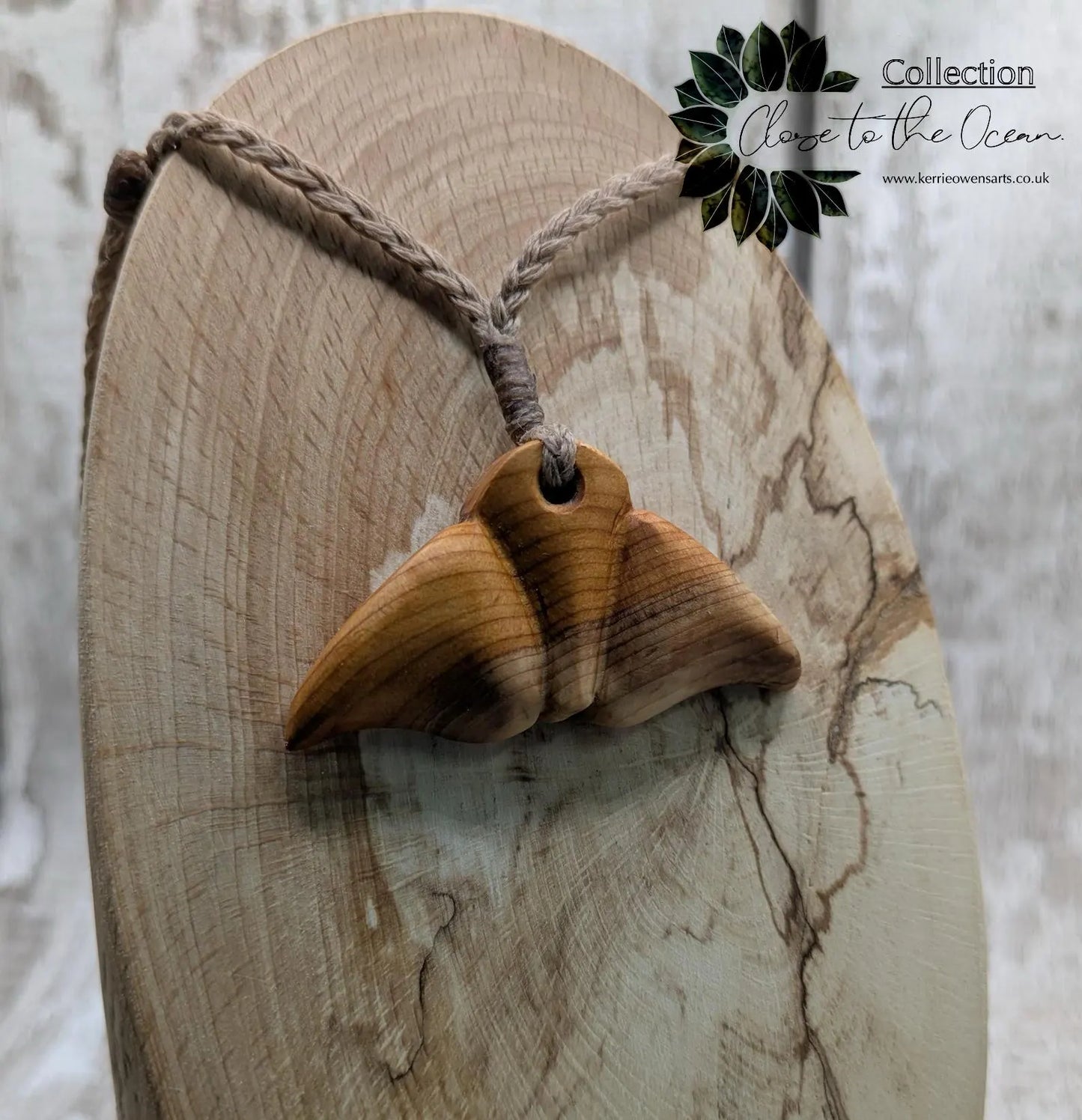Yew wood whales tail pendant.
