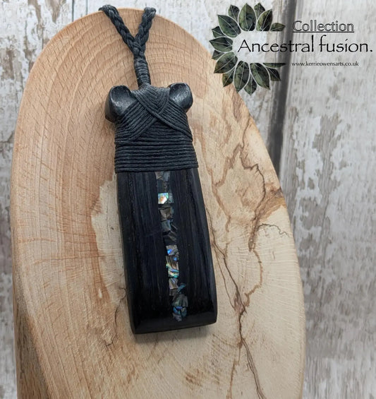 Fenland bog oak hei toki adze with NZ pāua shell pendant.