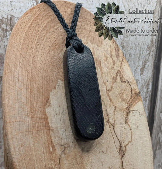 Bog oak hand carved pendant with a moldavite dot inlay.