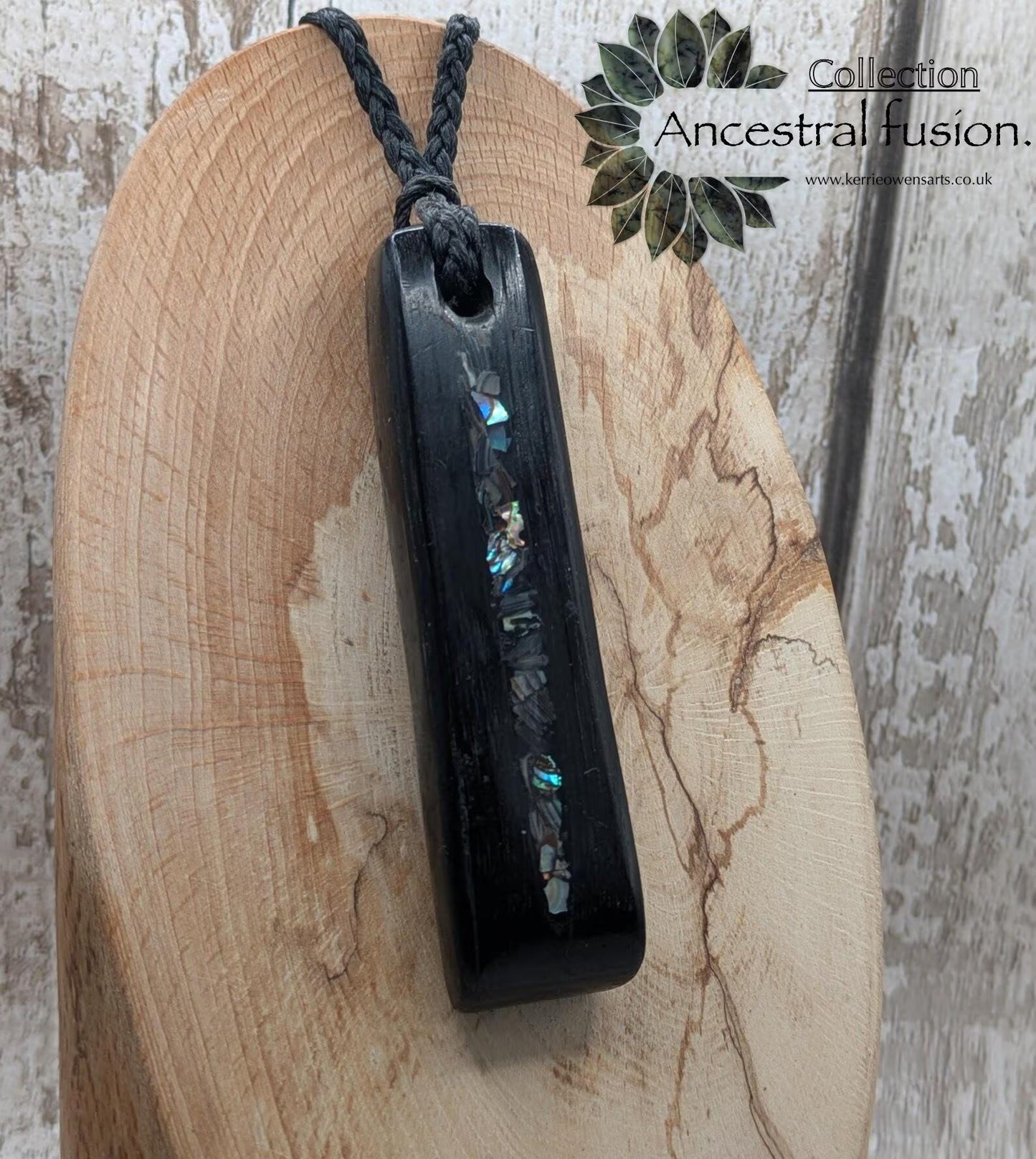 Bog oak and NZ rainbow pāua shell toki pendant.