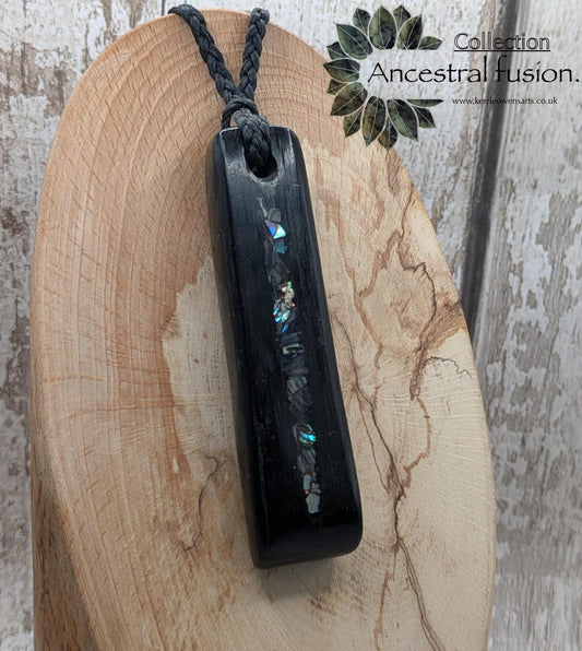 Bog oak and NZ rainbow pāua shell toki pendant.