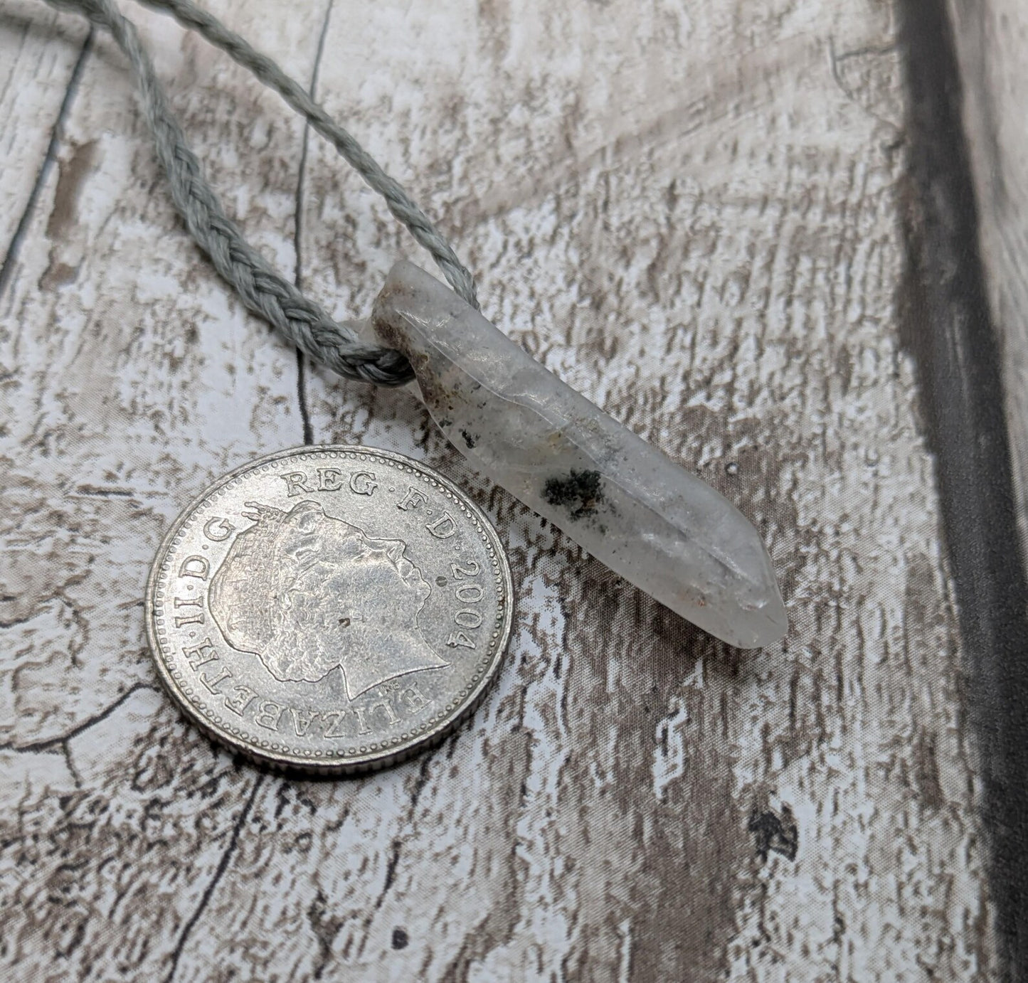 Quartz Crystal point pendant with inclusion.