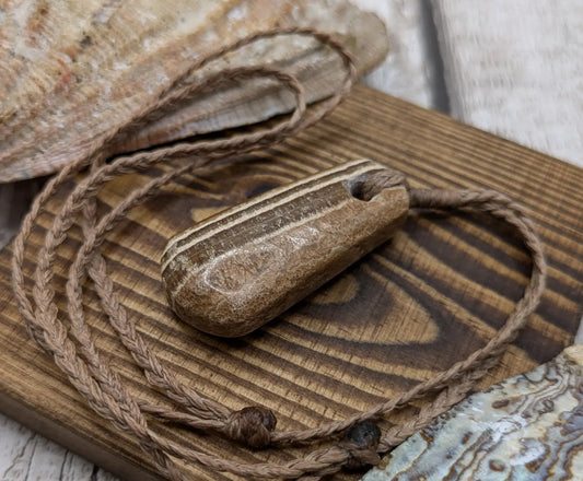 Striped argonite roimata teardrop pendant.