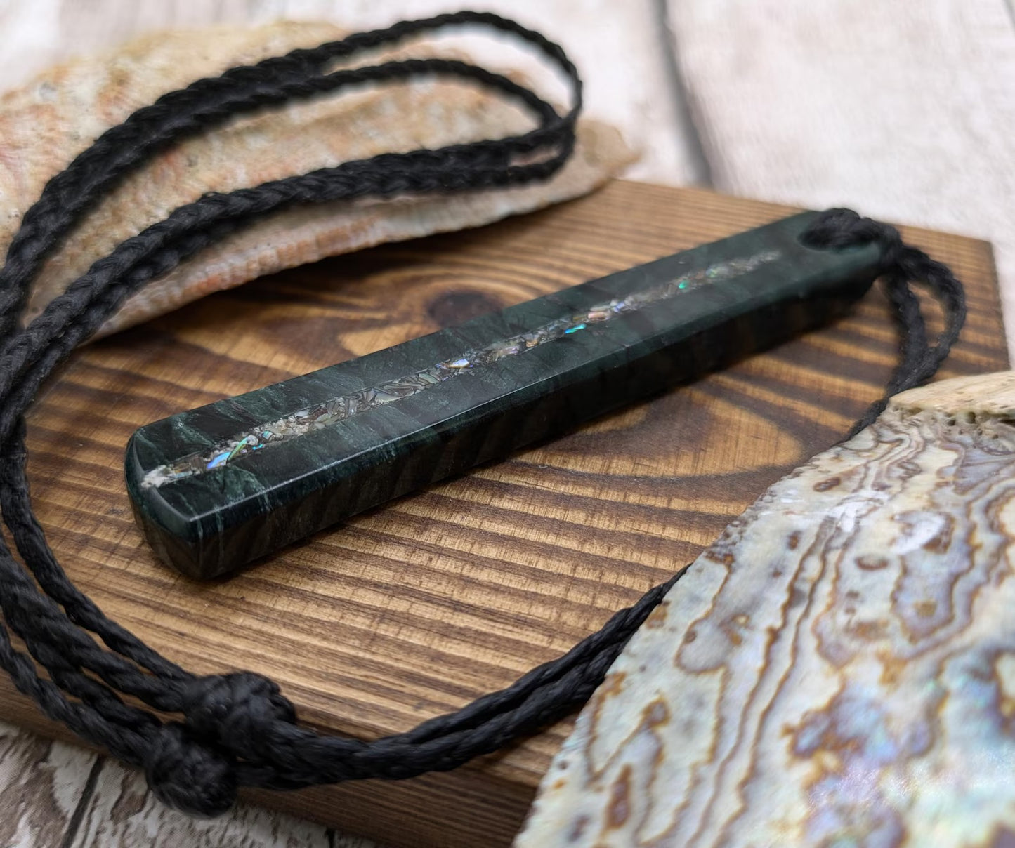 New Zealand serpentine roimata pendant with Rainbow Pāua inlay.