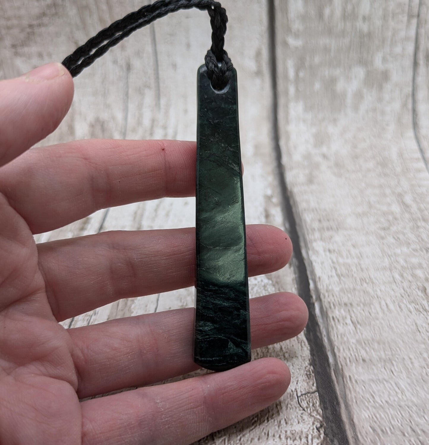 New Zealand serpentine roimata pendant with Rainbow Pāua inlay.