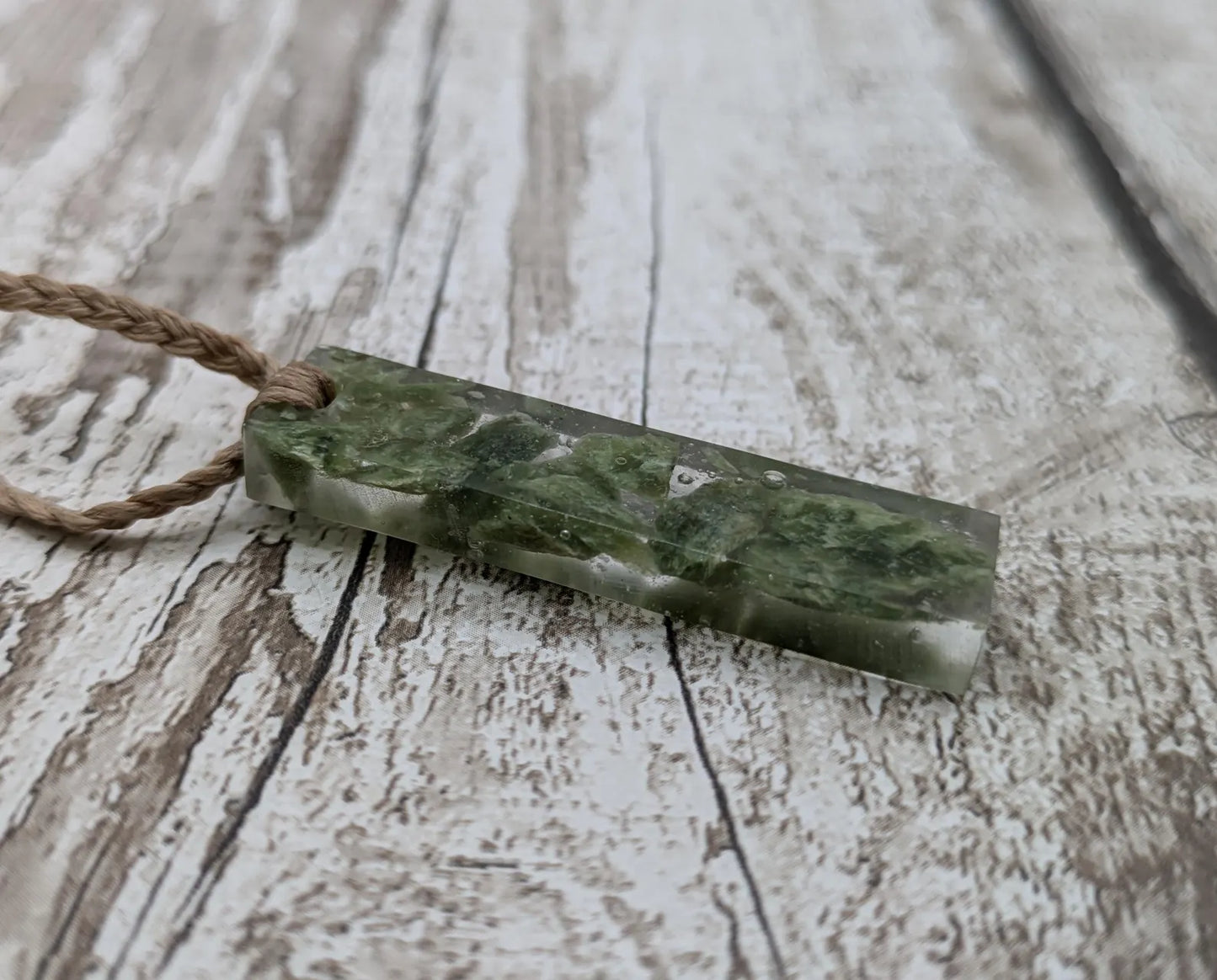 Alaskan jade in resin pendant.