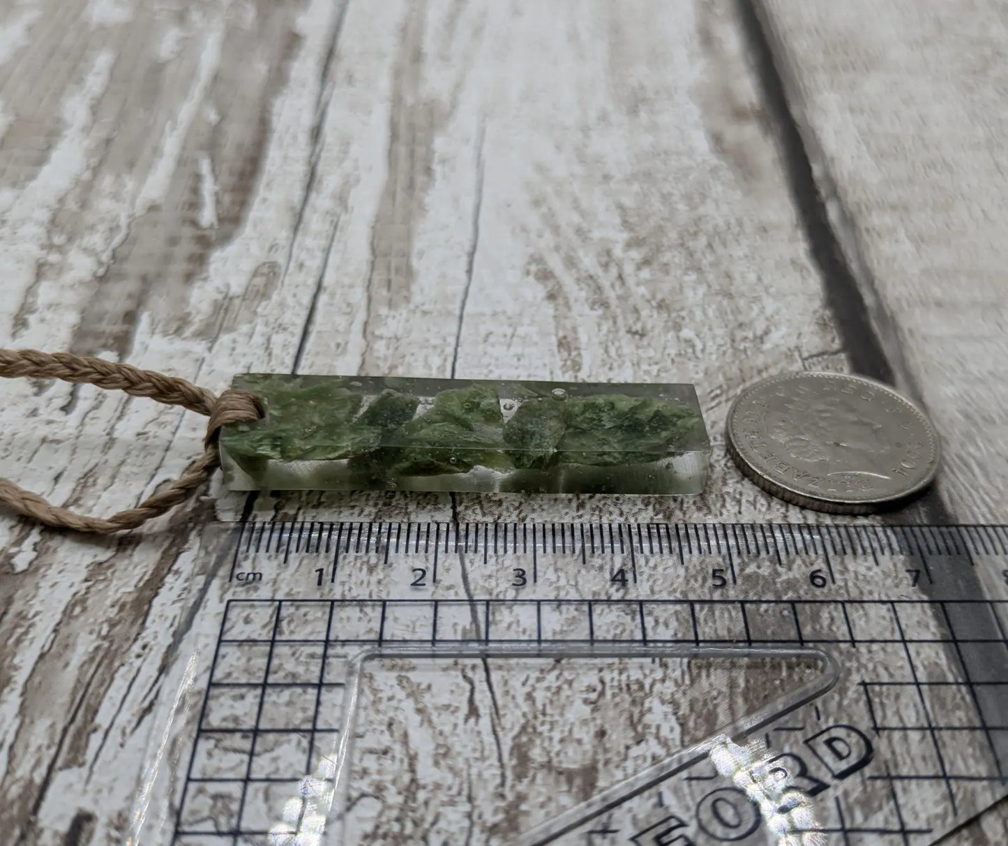 Alaskan jade in resin pendant.