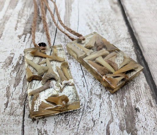 Fossilised sharks tooth in resin Christmas decoration.