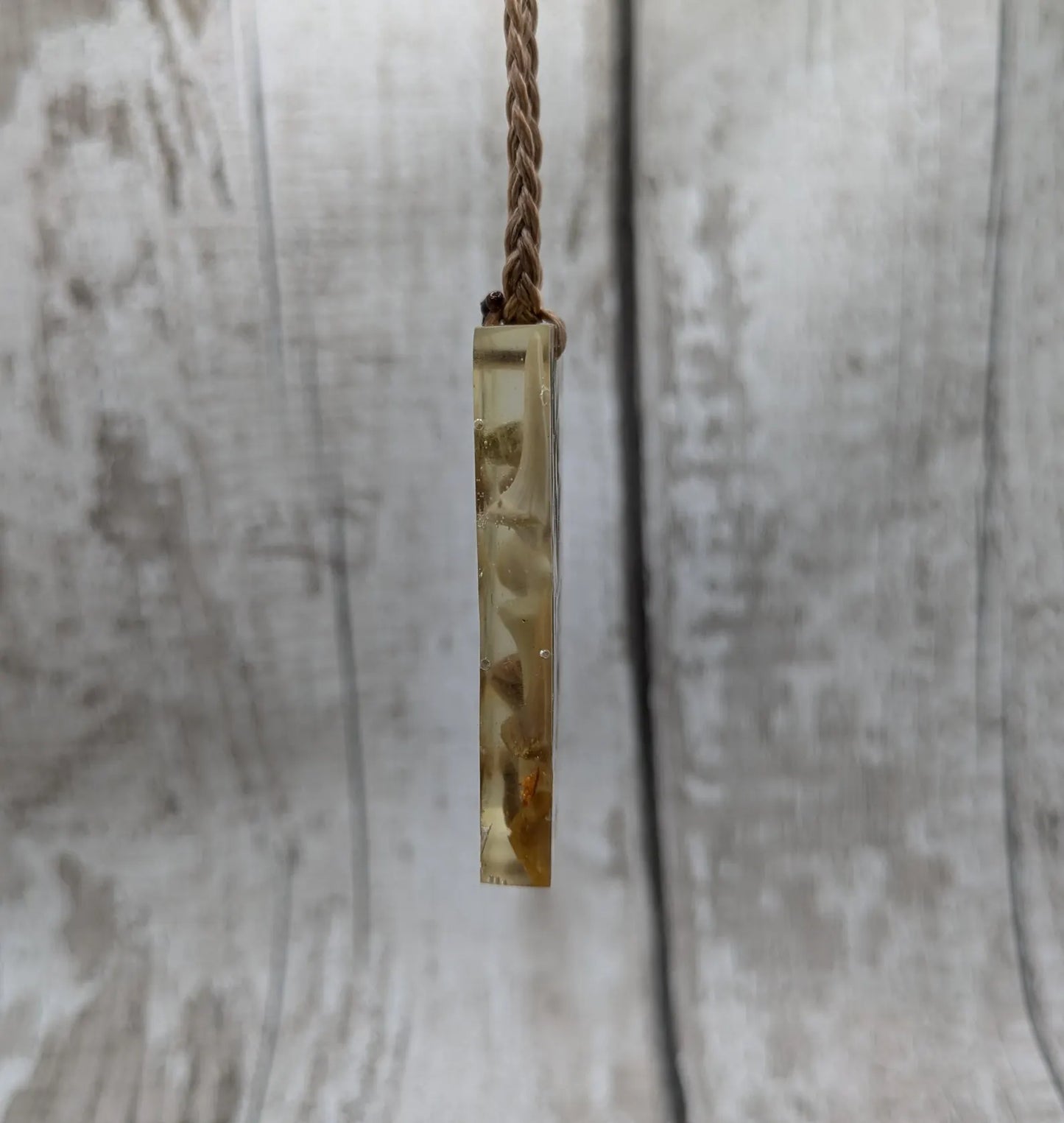 Fossilised sharks tooth in resin Christmas decoration.