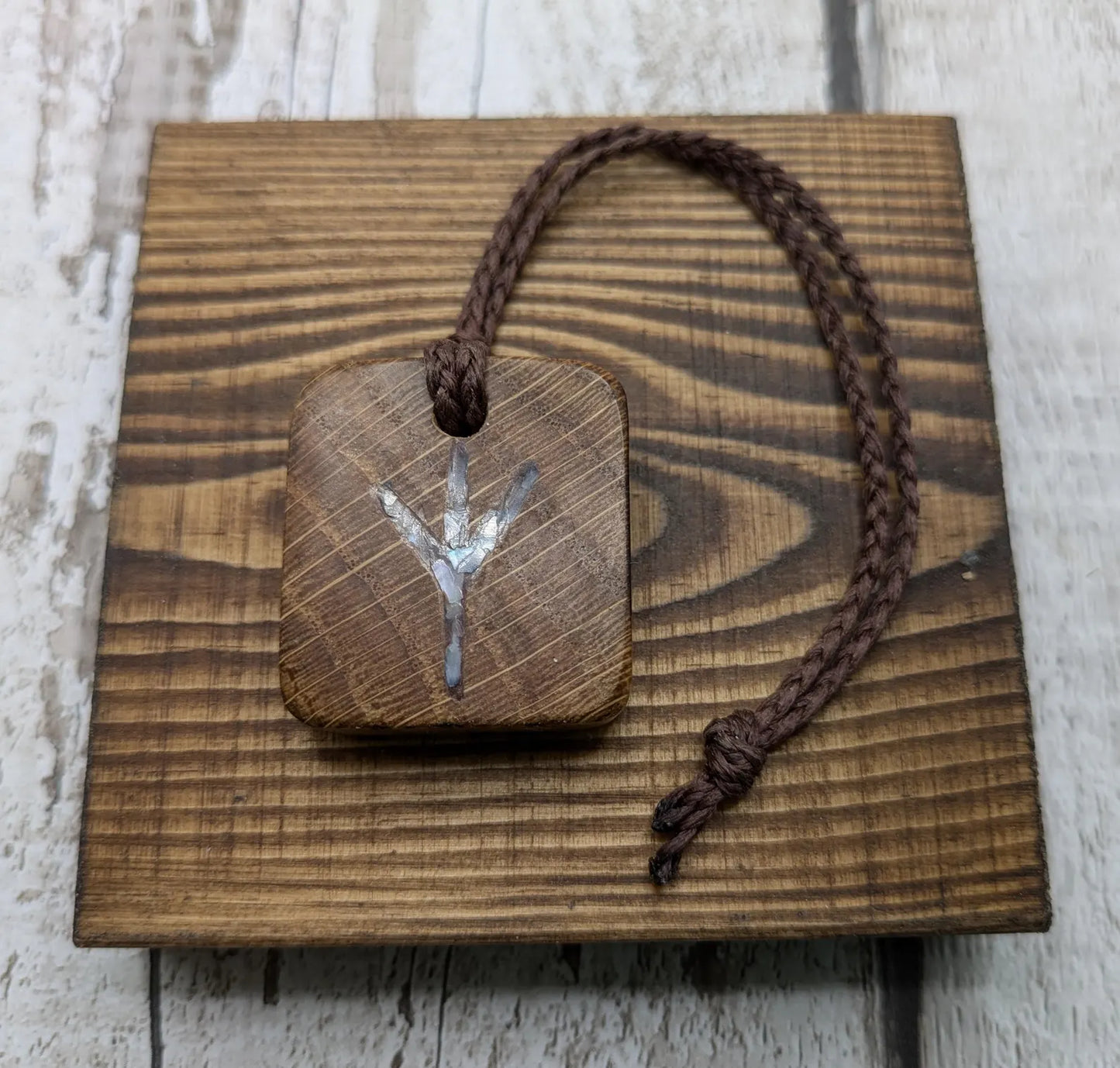 Algiz oak wood rune Christmas decoration with mussel shell inlay.