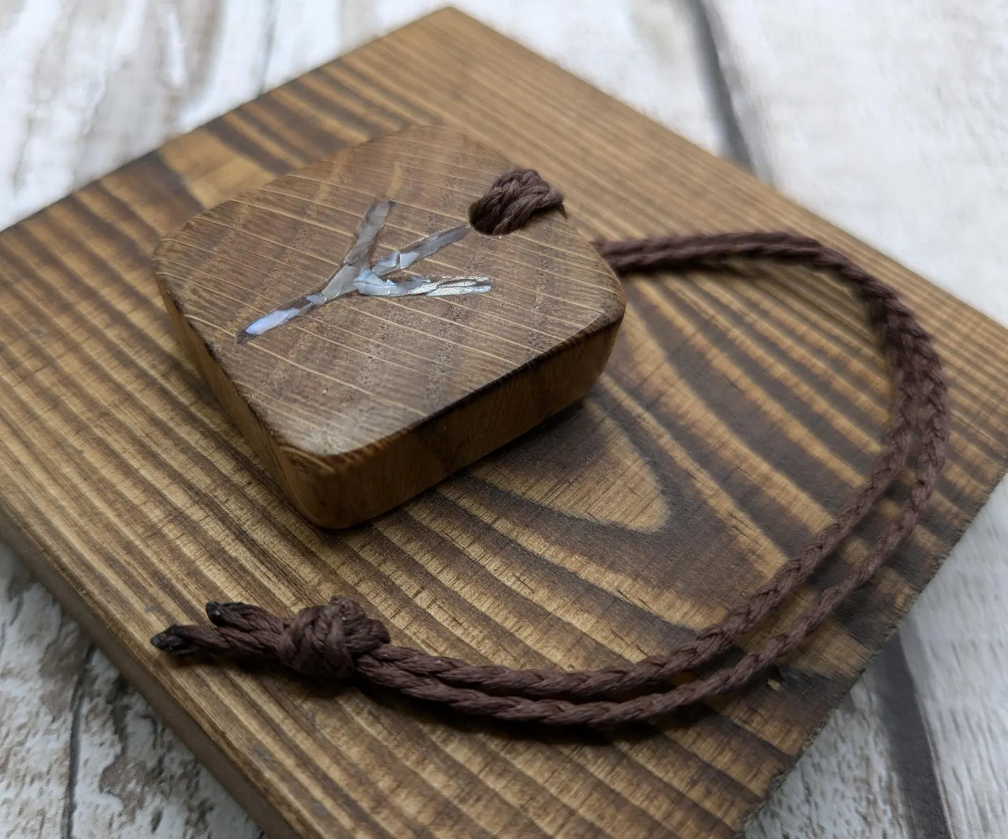 Algiz oak wood rune Christmas decoration with mussel shell inlay.