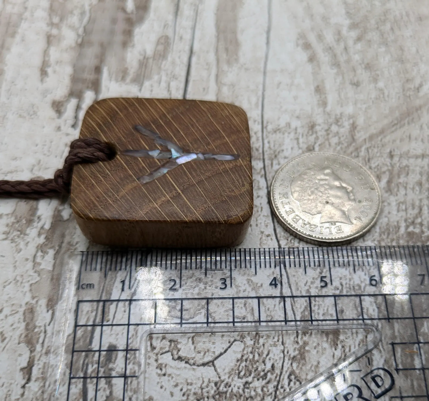 Algiz oak wood rune Christmas decoration with mussel shell inlay.