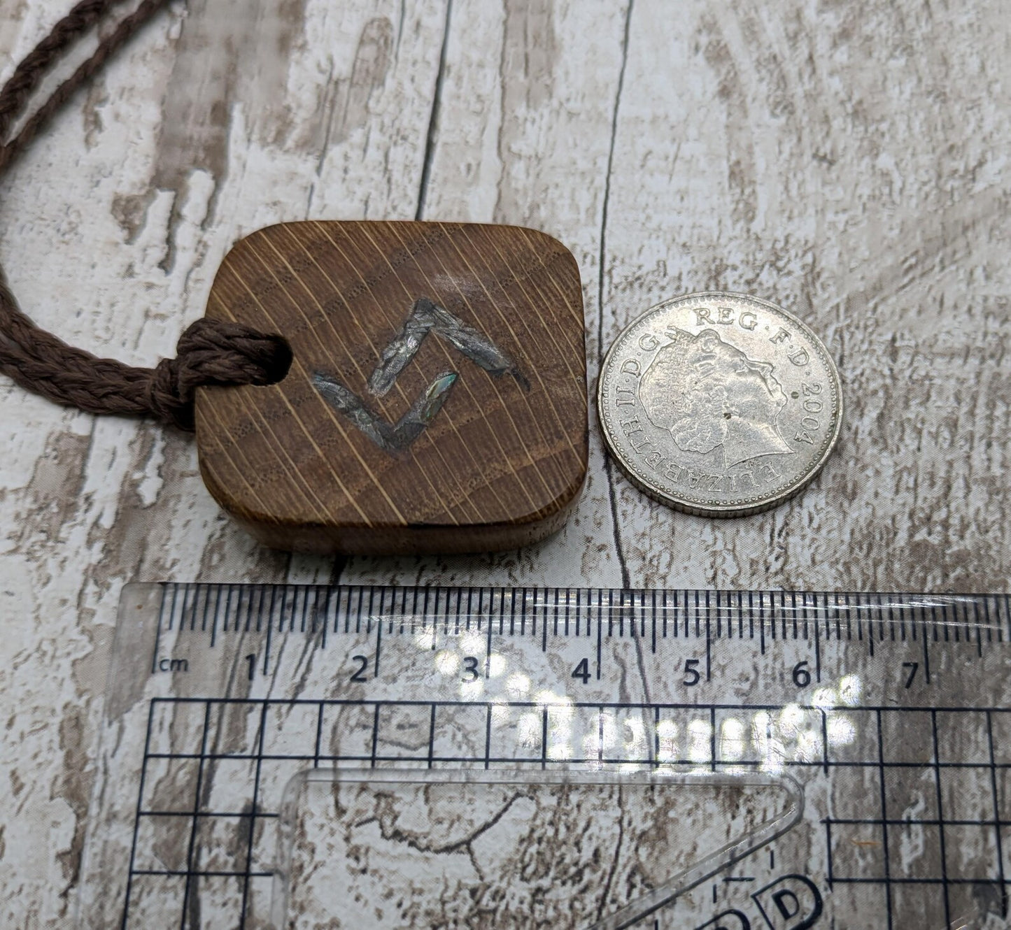 Oak wood jera Viking rune Christmas decoration with Pāua shell.