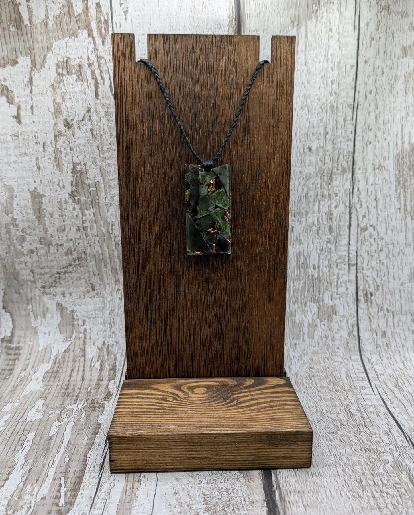 Mixed nephrite jade and copper pendant.