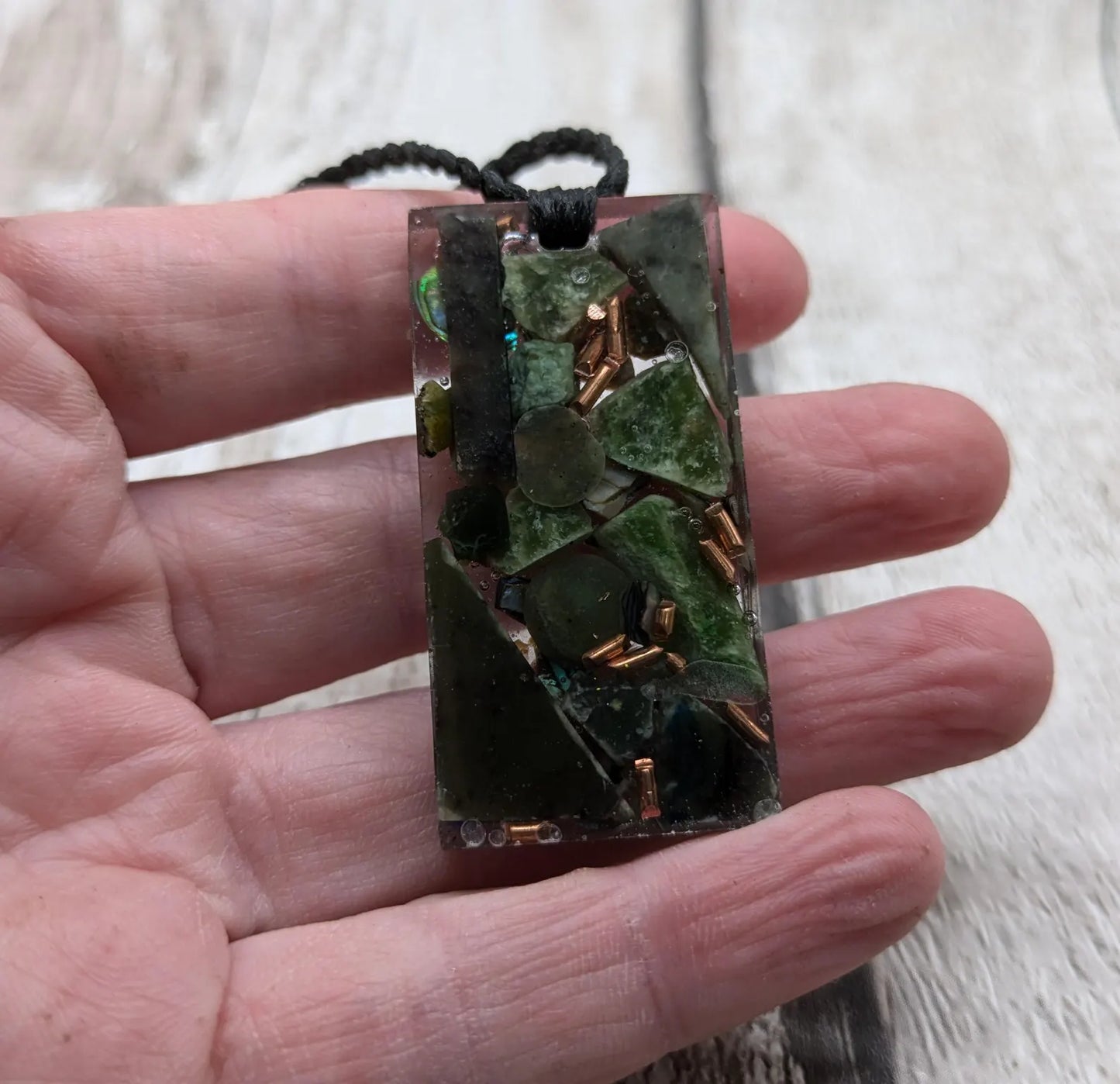 Mixed nephrite jade and copper pendant.