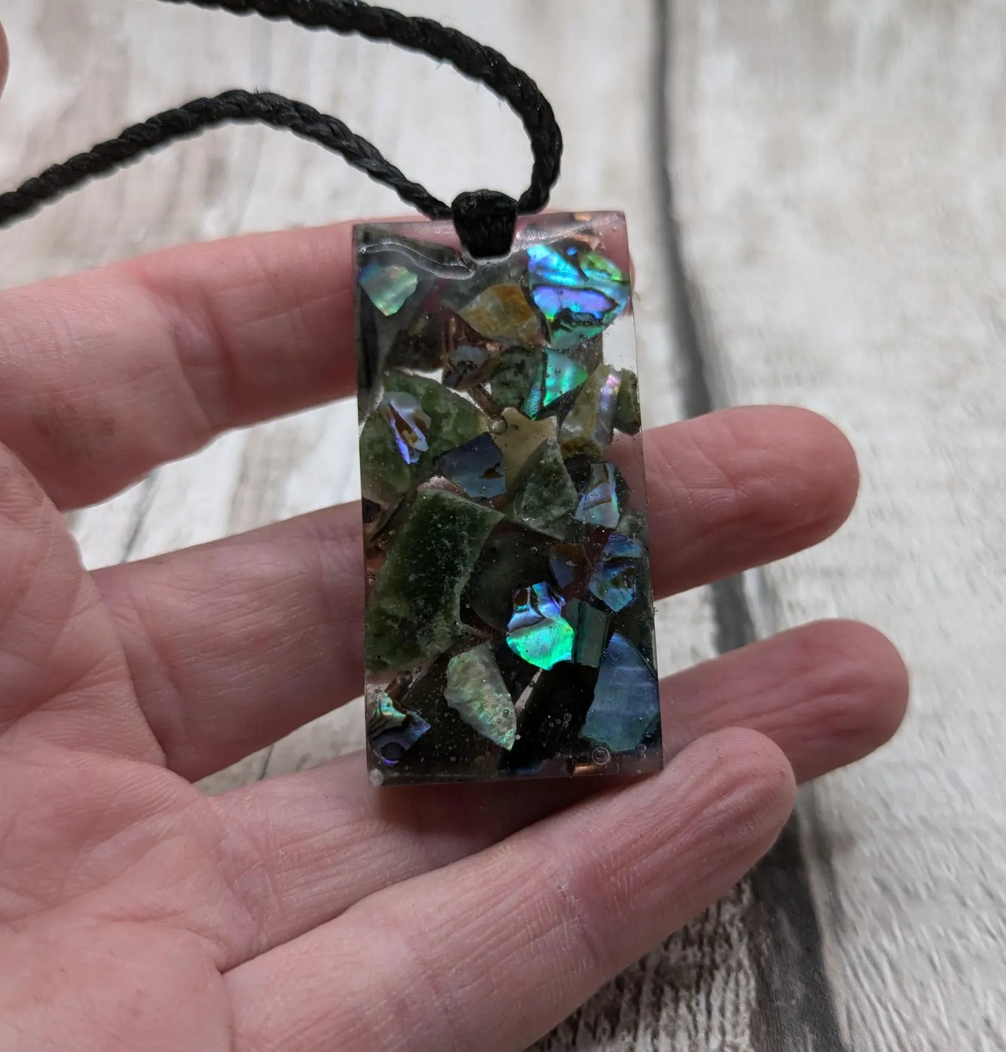 Mixed nephrite jade and copper pendant.