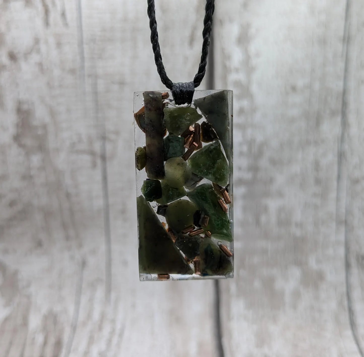 Mixed nephrite jade and copper pendant.