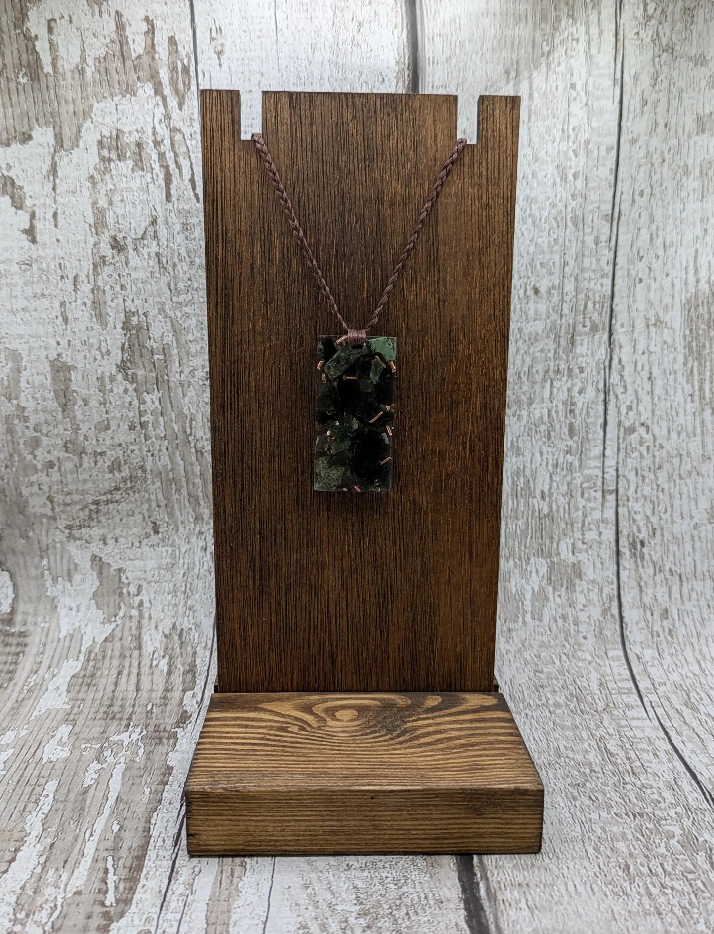 Mixed nephrite jade and copper in resin pendant.