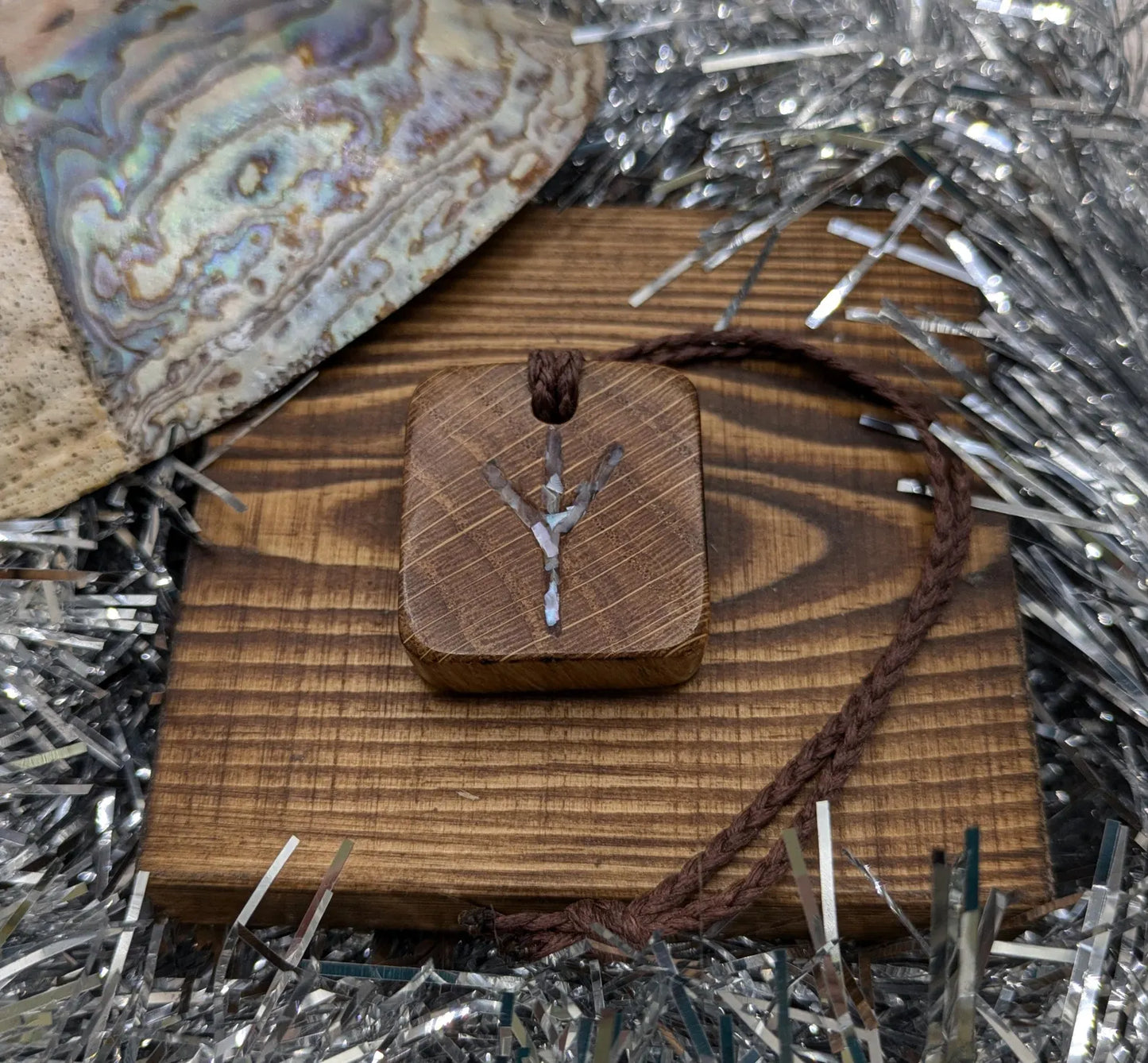 Algiz oak wood rune Christmas decoration with mussel shell inlay.